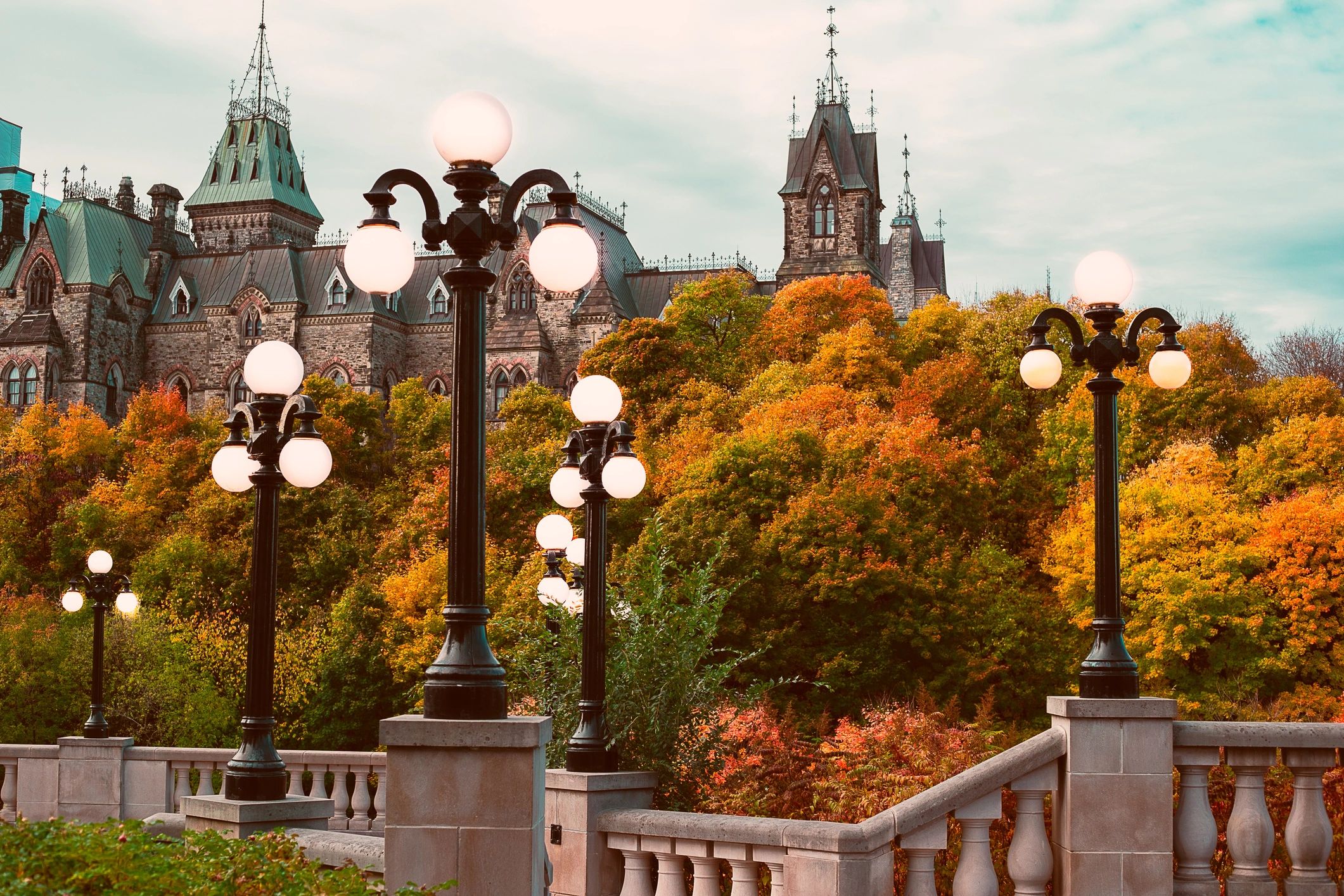 Street lamps and autumn foliage in front of Canada’s Parliament Buildings in Ottawa